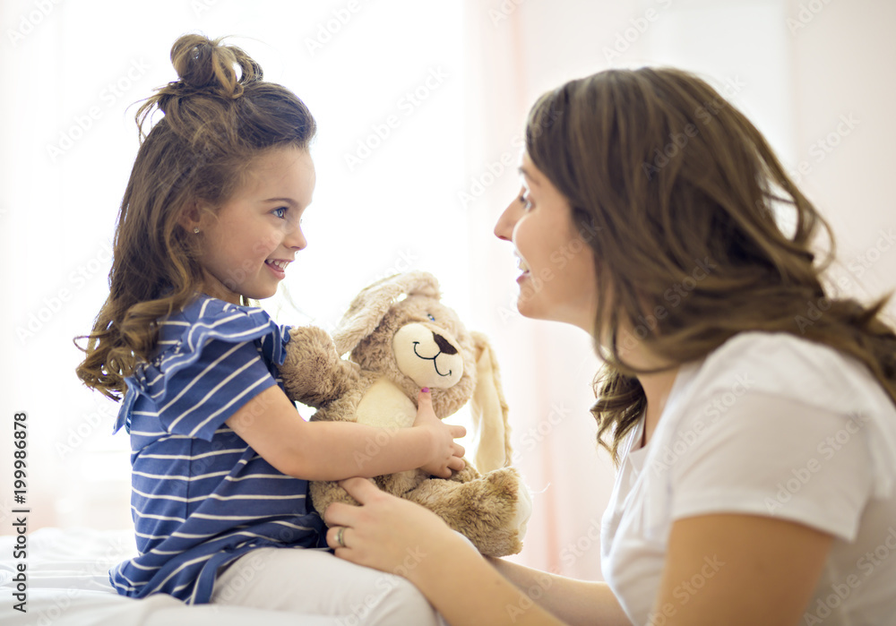 Mother and daughter enjoy in bed at home Mother and daughter enjoy in bed at home