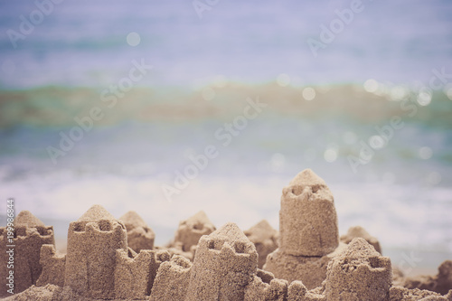 Sand castle standing on the beach. Travel vacations concept.
