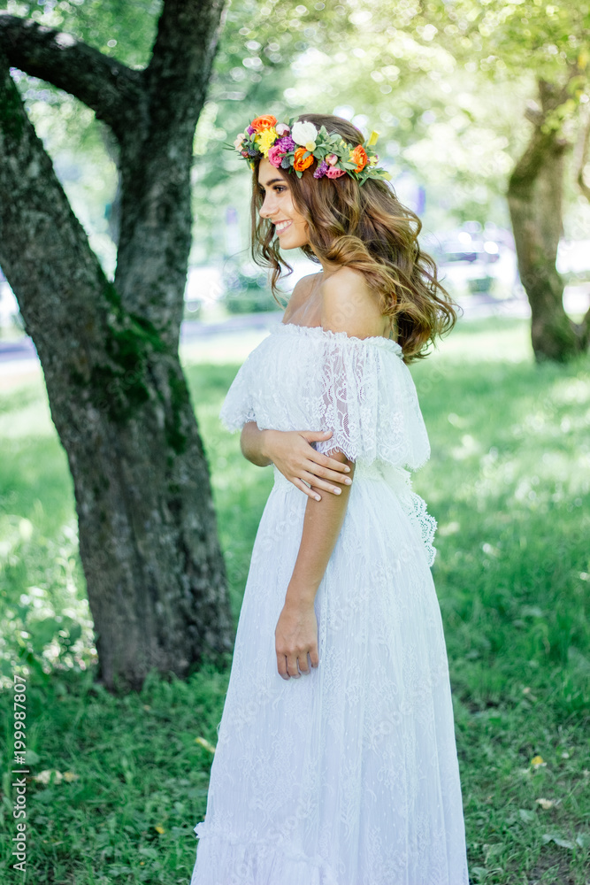 Nice bride staying on the green deep forest.