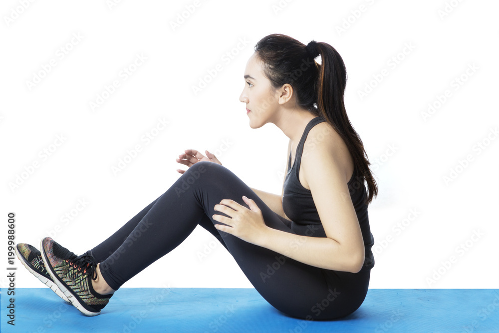 Arabian woman doing crunches on studio Arabian woman doing crunches on studio