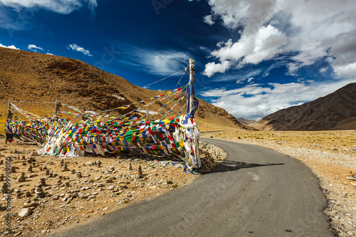 Road and Buddhist prayer flags (lungta) at Namshang La pass. Lad