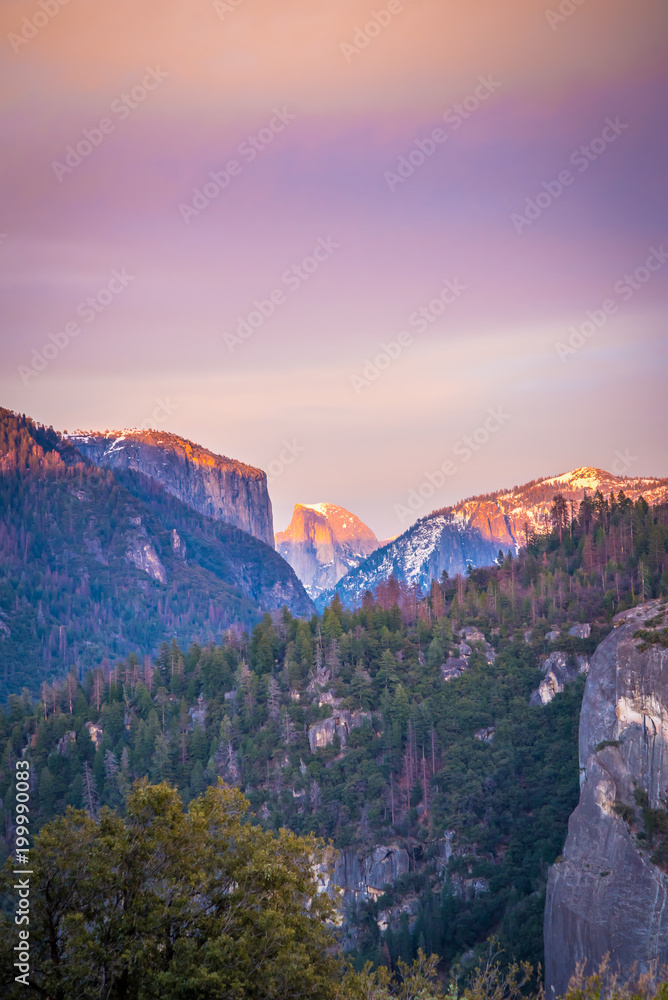 half dome in the distance at sunset at yosemite 