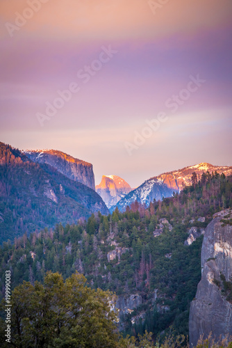 half dome in the distance at sunset at yosemite  © Joseph