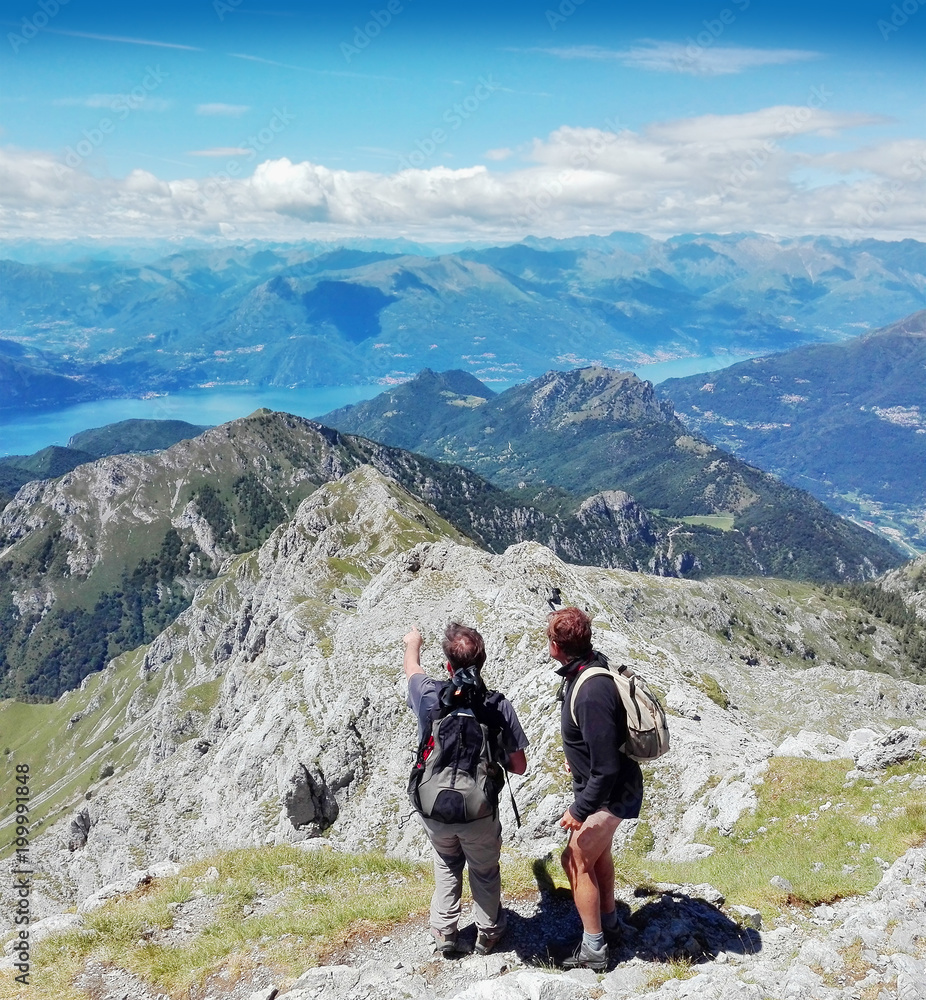 hikers lloking the panorama of the lake of Como and lecco and resegone