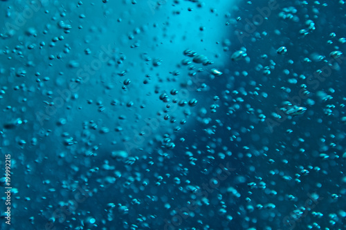Blue clear water with bubles, abstract liquid background
