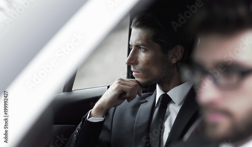 business people sitting in car