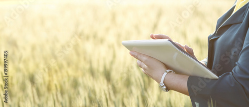 Business woman using digital tablet in the field