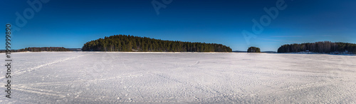 Falun - March 31, 2018: Panorama of the frozen lake of Framby Udde near the town of Falun in Dalarna, Sweden photo