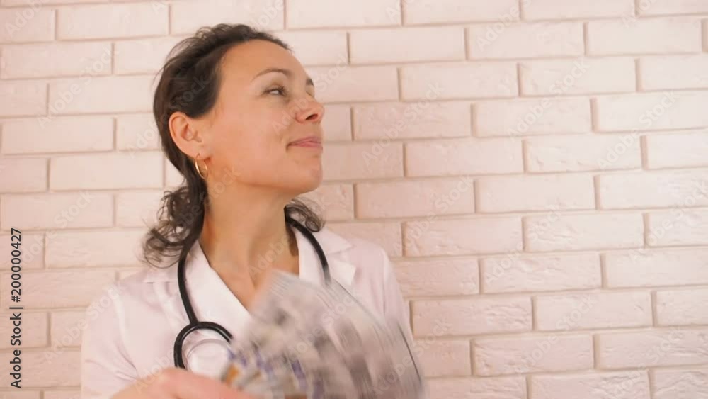 Fan with cash. Happy doctor waving money. Fan with cash. Happy doctor waving money.