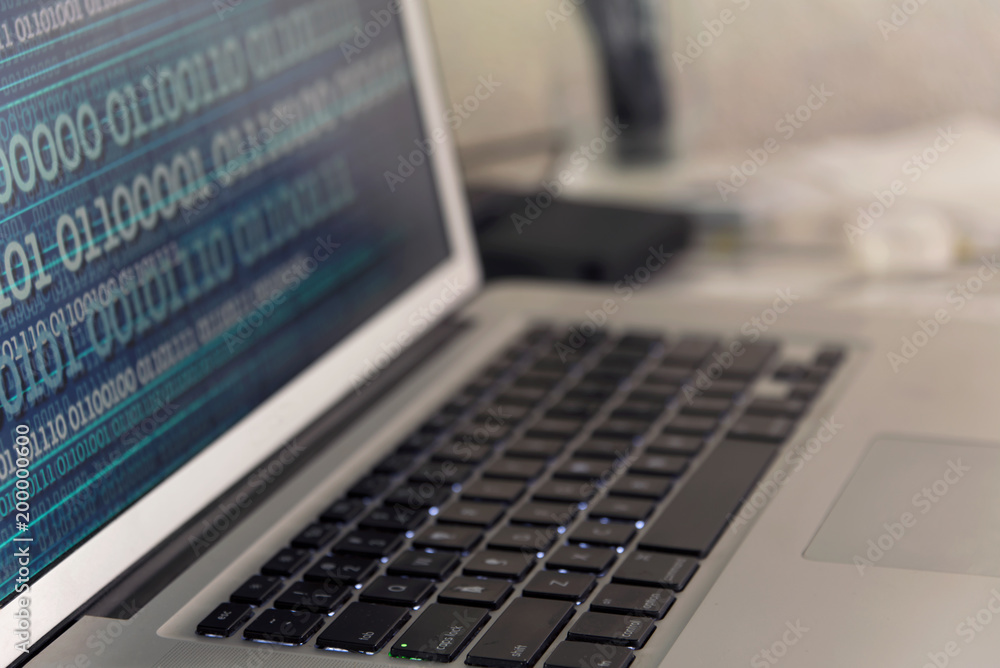 Computer data concept - laptop keyboard with binary data on screen - analytics, binary numbers, big data, information Computer data concept - laptop keyboard with binary data on screen - analytics, binary numbers, big data, information