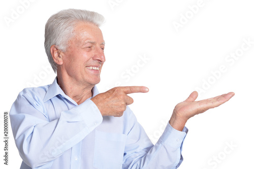 Mature man pointing on white background