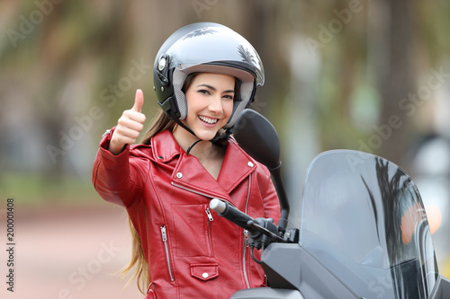 Biker looking at you with thumb up outside