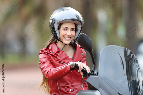 Biker on her motorbike looking at camera