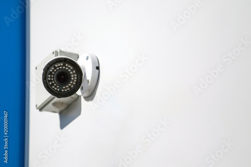 outdoor surveillance camera on a white wall