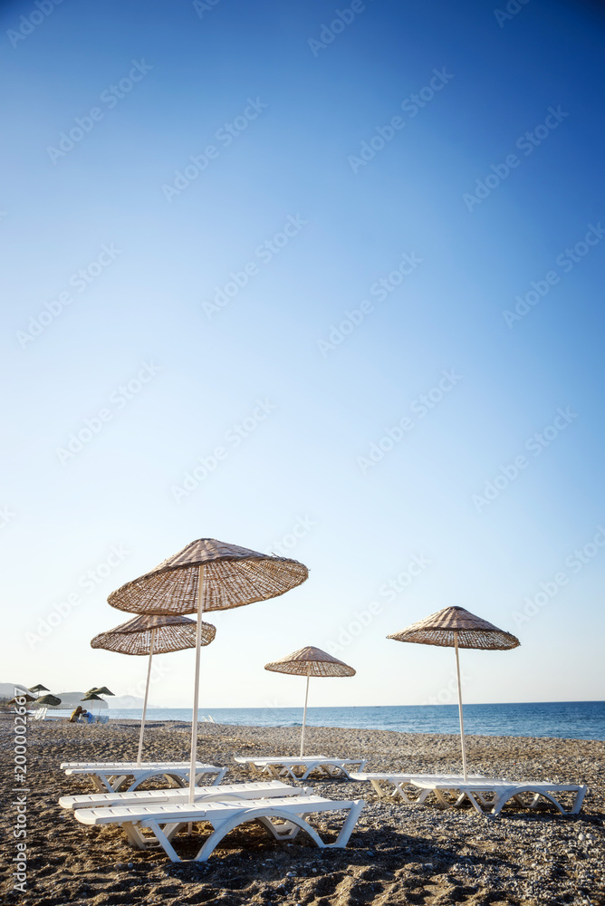 A straw umbrella on a beautiful tropical beach