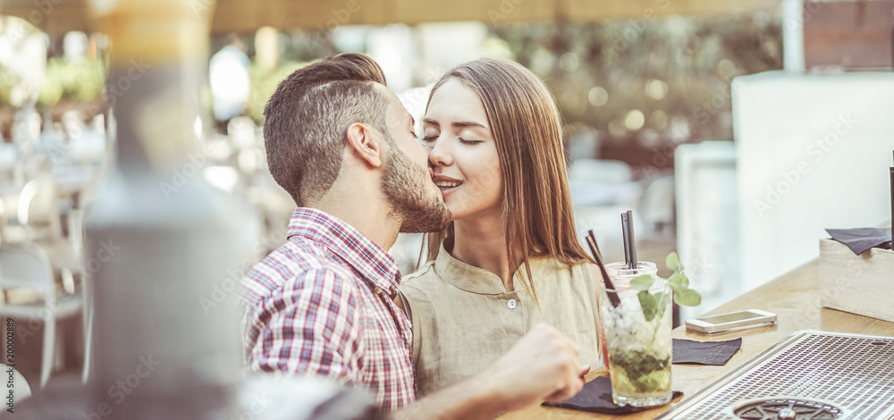 Happy trendy kissing in lounge cocktail bar - Young people having tender  moments in summer vacation - Party, relationship, fun and date - Focus on  woman face Stock Photo | Adobe Stock