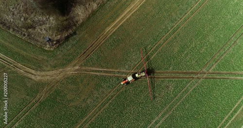 Tractor spray fertilize on field with chemicals in agriculture field.