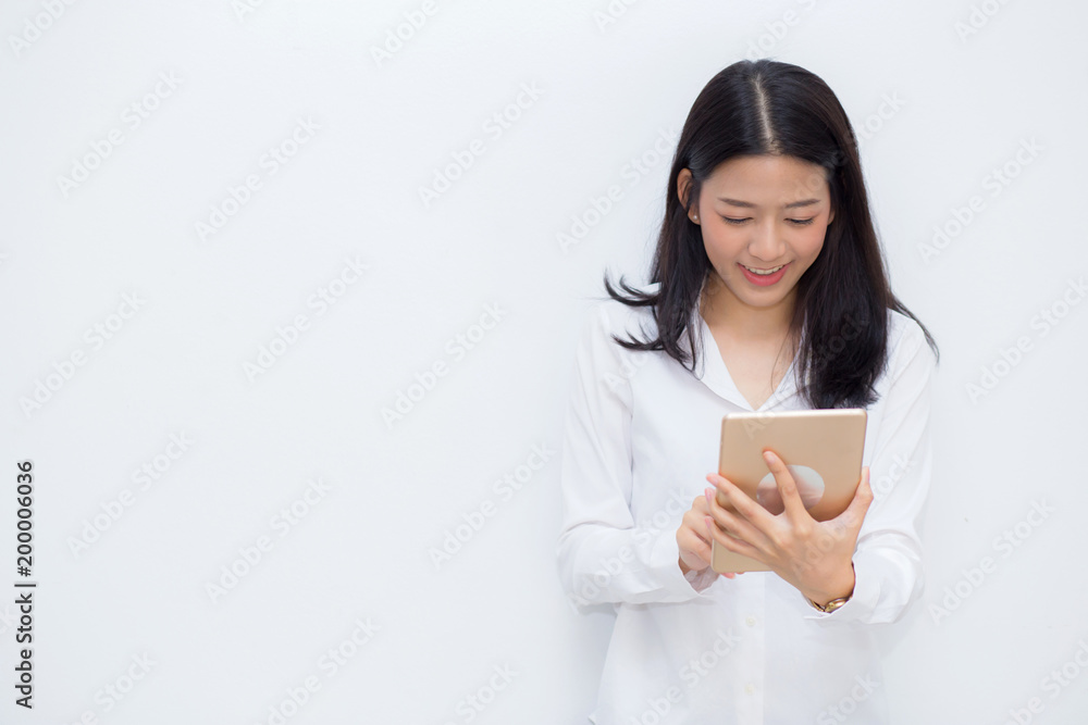 Beautiful portrait young asian woman using tablet computer cement background, businesswoman sitting looking tablet, communication concept. Beautiful portrait young asian woman using tablet computer cement background, businesswoman sitting looking tablet, communication concept.