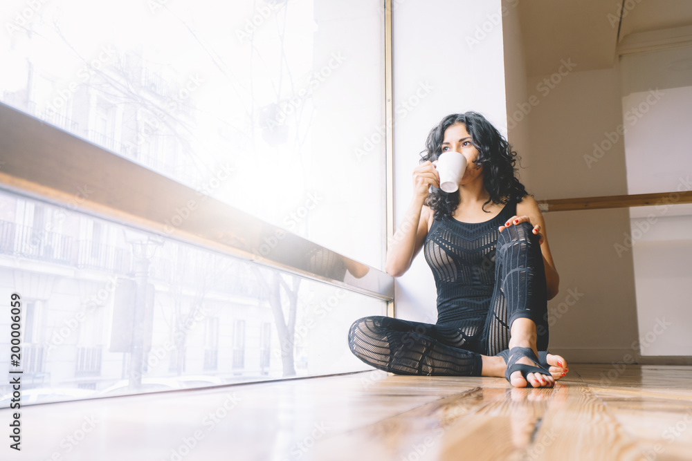 Woman having coffee in dance class Woman having coffee in dance class