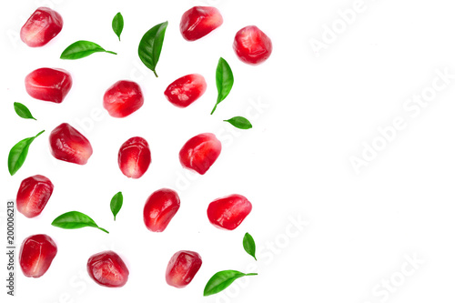 pomegranate seeds decorated with green leaves isolated on white background with copy space for your text. Top view