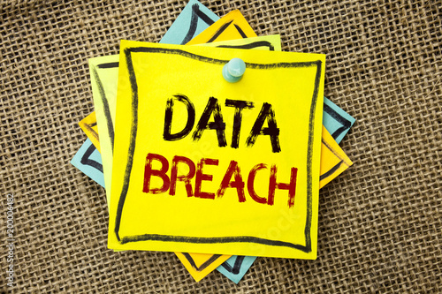 Text sign showing Data Breach. Conceptual photo Stolen Cybercrime Information Hacking Security Malicious Crack written on Sticky Note Paper attached to jute background with Thumbpin on it. photo