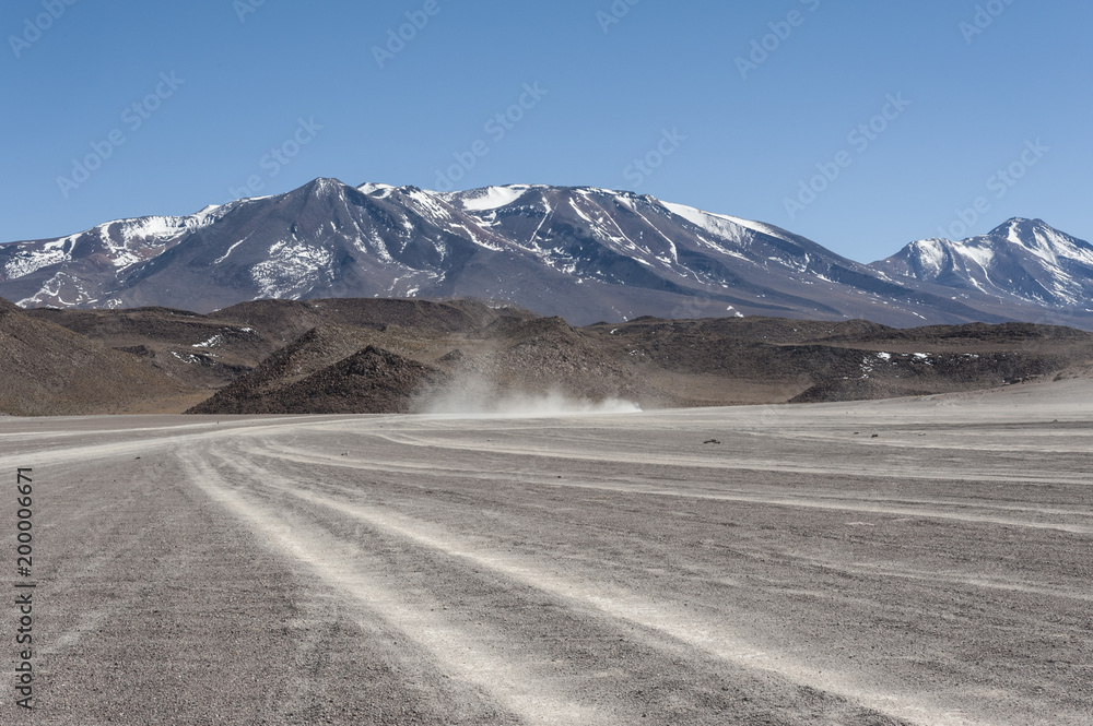 Unpaved Road in Altiplano of the Siloli desert, part of the Reserva Eduardo Avaroa, Bolivia - at an altitude of 4600m near the border of Chile and the Atacama desert, South America