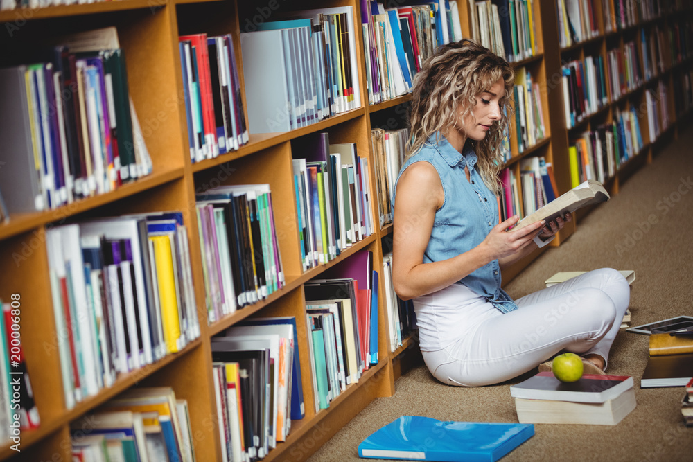 Woman sitting and reading a book Woman sitting and reading a book