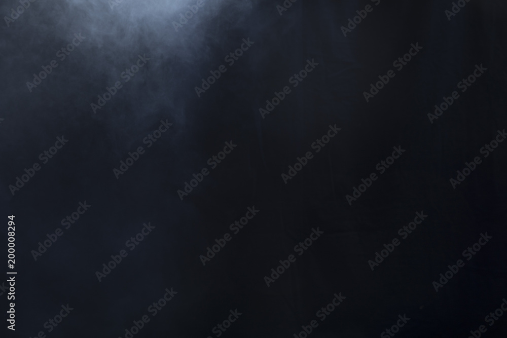 Smoke clouds create fog on left side of black background