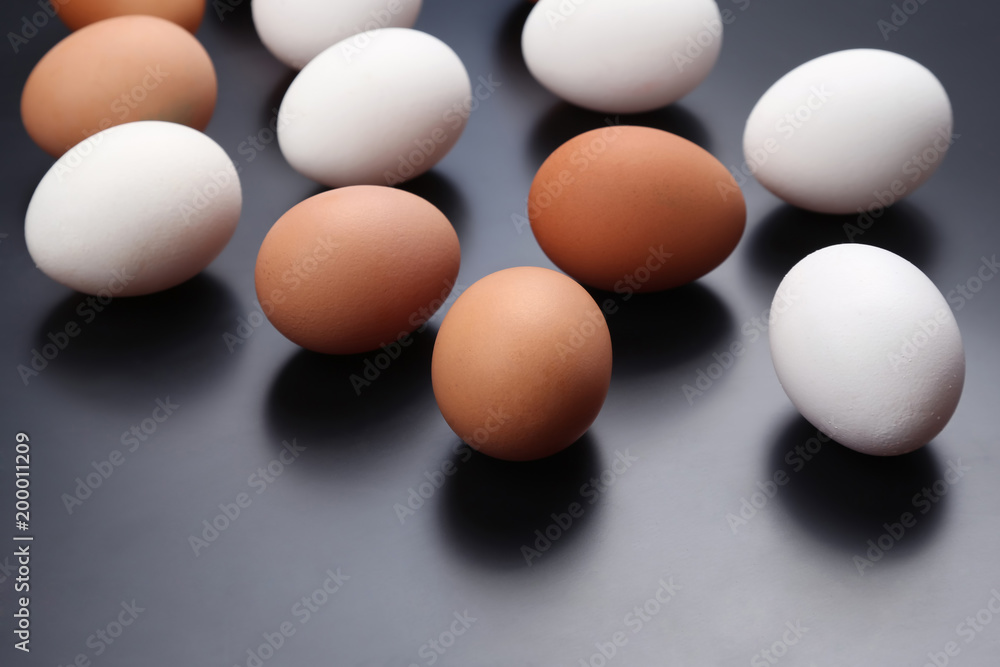 different chicken eggs lie on dark background different chicken eggs lie on dark background