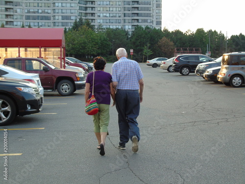 Old couple walking in a parking lot © Jonathan Dahoah Hale