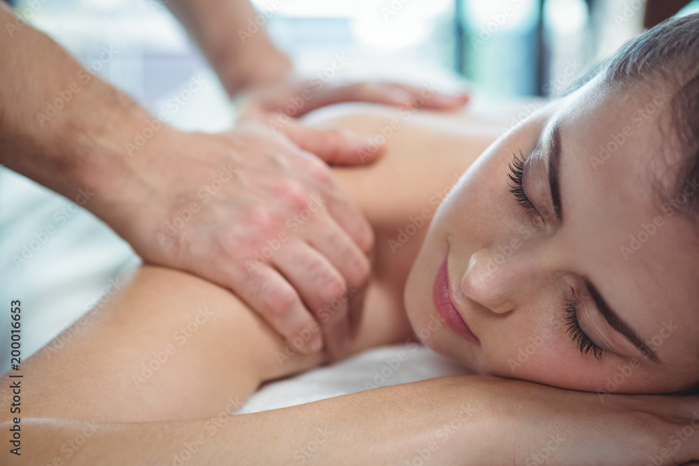 Physiotherapist giving physical therapy to the shoulder of a female patient Physiotherapist giving physical therapy to the shoulder of a female patient