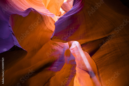 Beam of light in the underground labyrinth of colored sand of the slot Lower Antelope Canyon in Page Arizona creates an unforgettable combination of light shadows and colors