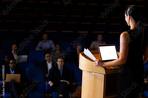 Female business executive giving a speech