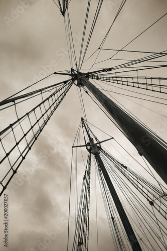 Old boat masts against stormy sky