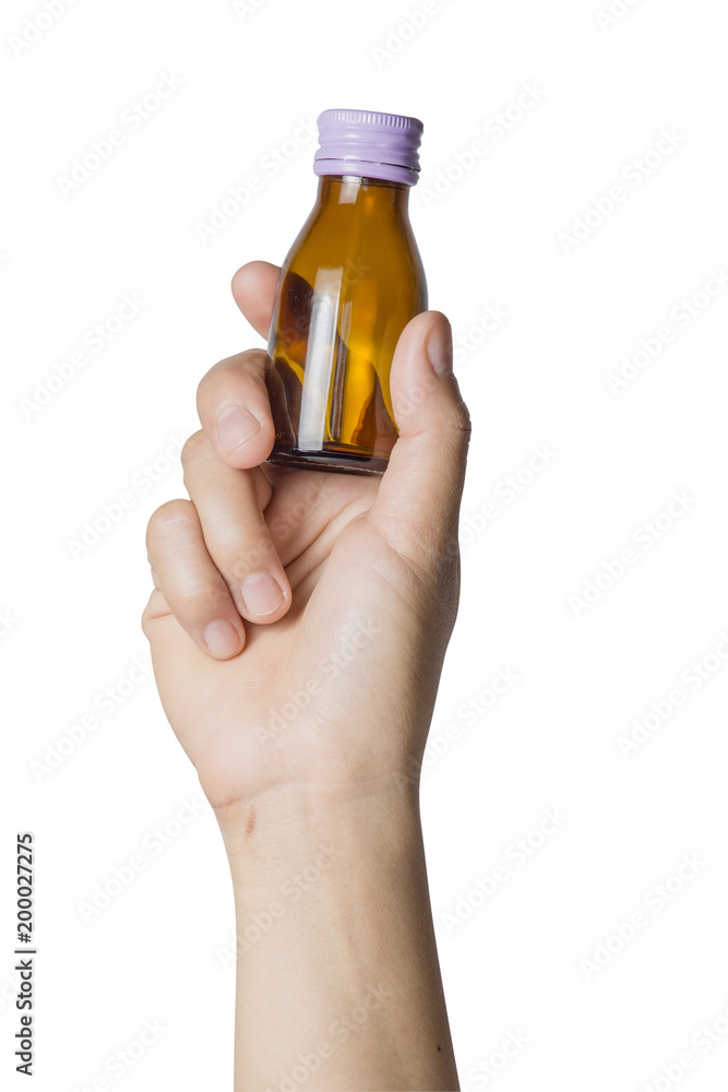 Woman's hand holding empty small brown medicine bottle liquids transparent on white background. File contains a clipping path. Woman's hand holding empty small brown medicine bottle liquids transparent on white background. File contains a clipping path.