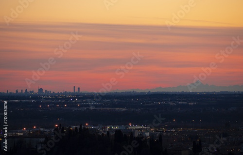 The Monviso and the skyscrapers of Milan from the walls of Bergamo during the sunset