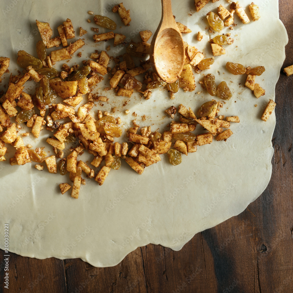 Raw dough stuffing apple roll strudel top view Raw dough stuffing apple roll strudel top view