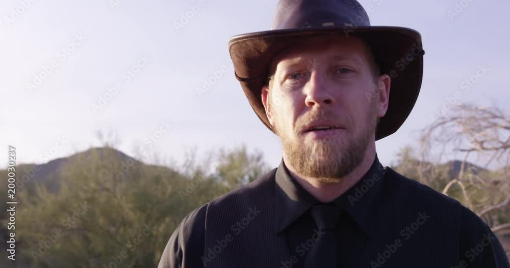 American cowboy looks directly into camera - close up slow motion American cowboy looks directly into camera - close up slow motion