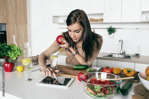 Woman reading recipe simple summer salad tablet Simple healthy food