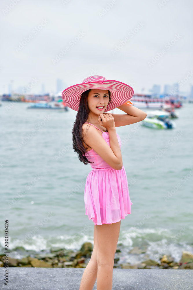 Travel Concepts. Beautiful girl relaxing on the beach. Beautiful girl is happy to come to the beach. Beautiful girl is walking the beach. Happy women and relaxing on the seashore. Travel Concepts. Beautiful girl relaxing on the beach. Beautiful girl is happy to come to the beach. Beautiful girl is walking the beach. Happy women and relaxing on the seashore.