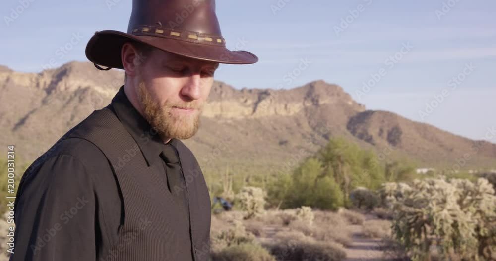 Creepy Cowboy stares towards camera as he walks - villain? Creepy Cowboy stares towards camera as he walks - villain?
