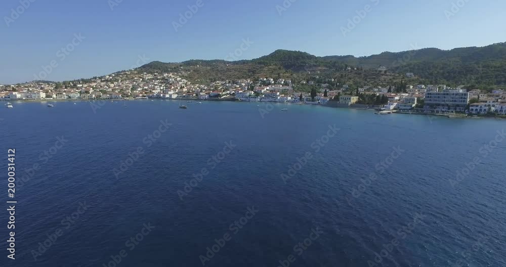Aerial establishing shot of the rustic island of Spetses in a warm summer