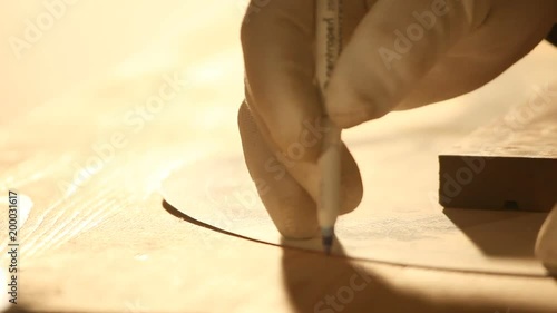 close up of marking a wooden board with a pen based on the mold