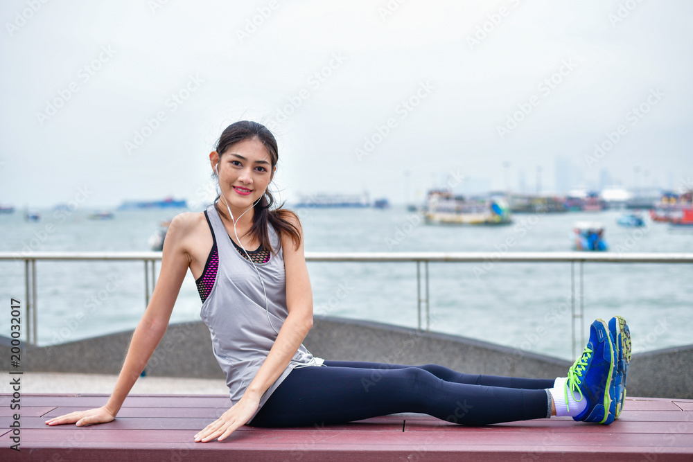 Sports concept. Beautiful girl is exercising on the beach with warm up. Beautiful girl is happy to exercise. Sports concept. Beautiful girl is exercising on the beach with warm up. Beautiful girl is happy to exercise.