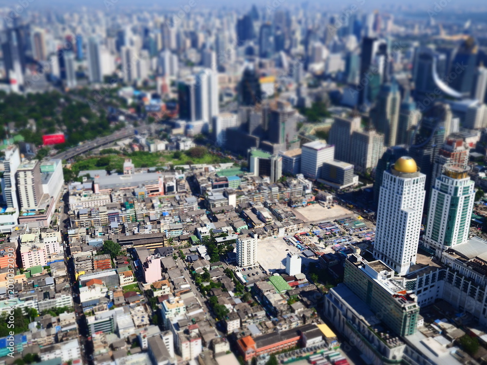 Miniature Tilt shift lens effect of aerial view of midtown building in Bangkok.