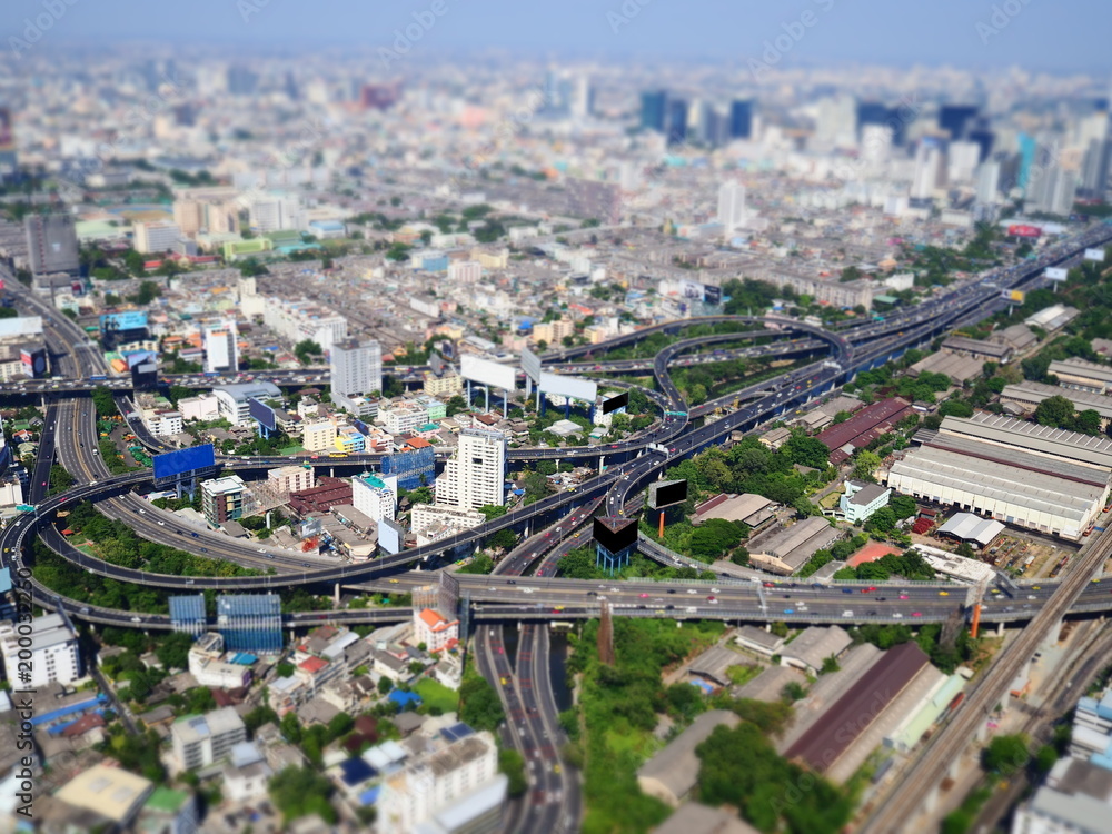 Miniature Tilt shift lens effect of highway in urban modern buildings in Bangkok.