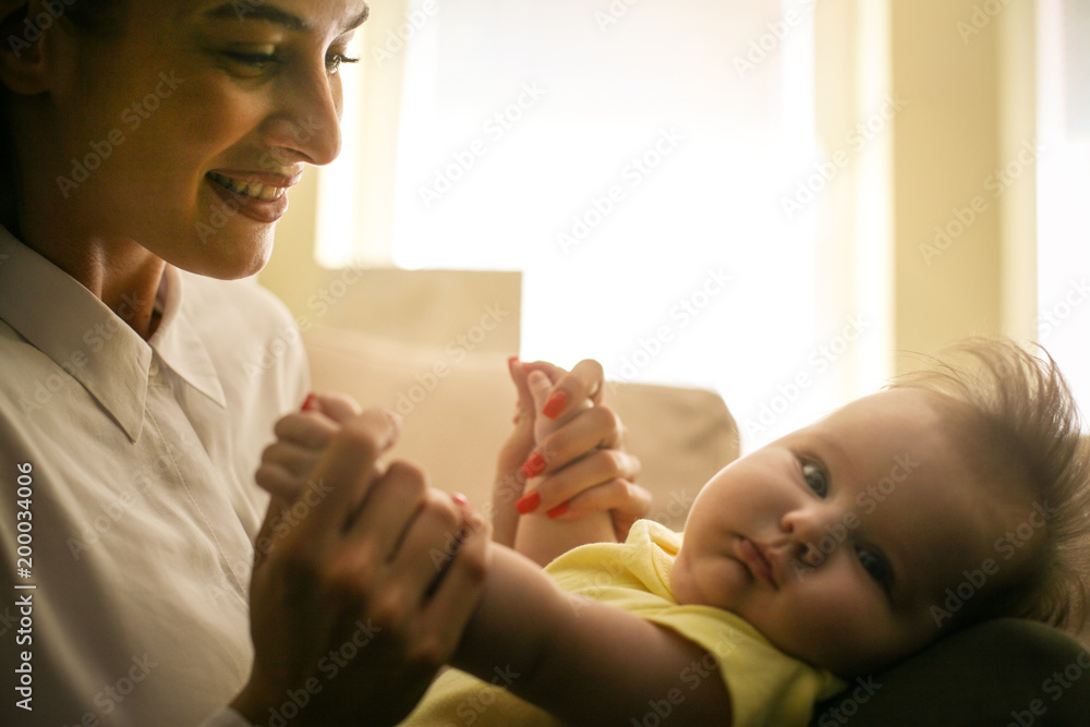 Single mother playing with her little girl at home. Close up. Single mother playing with her little girl at home. Close up.
