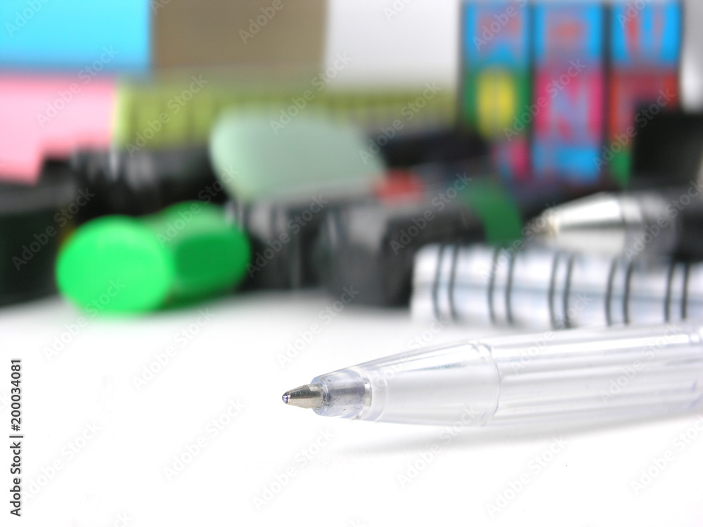 close up.white ball point pen on the background of school supplies close up.white ball point pen on the background of school supplies