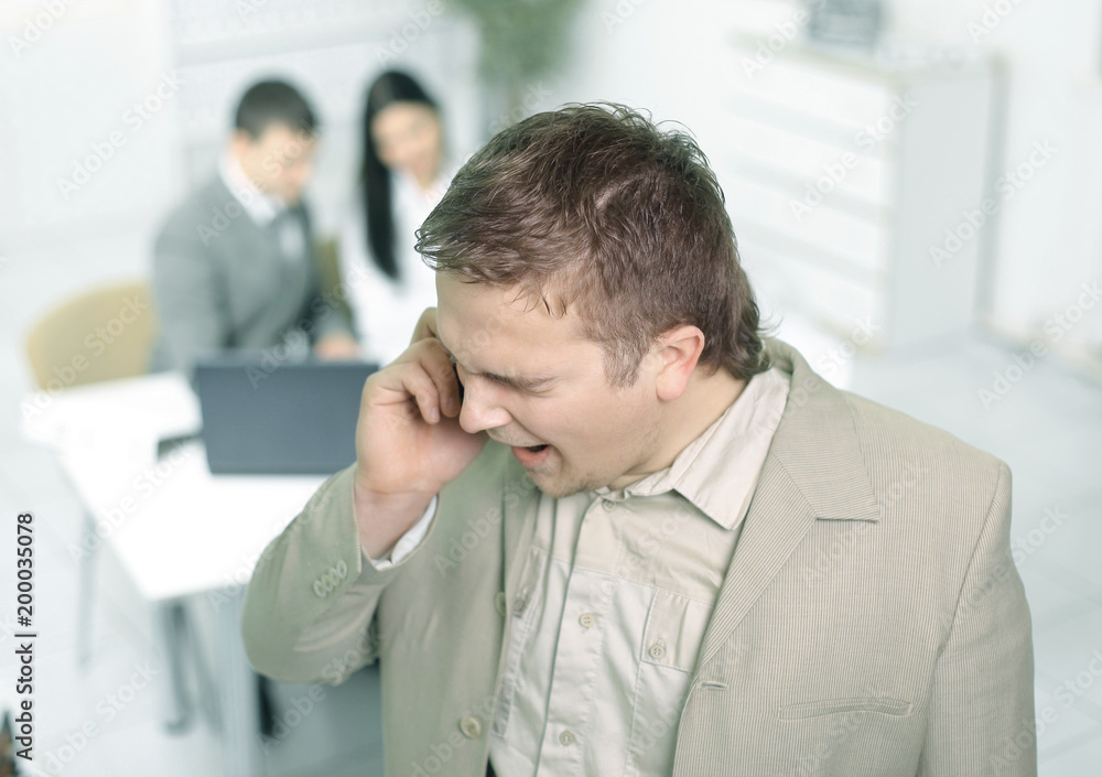 Fototapeta premium closeup.Manager talking on mobile phone in office