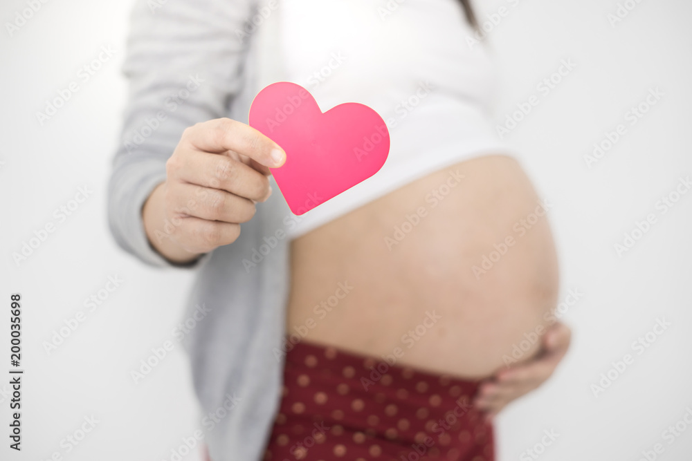 Pregnant woman with heart shaped on tummy. Pregnant woman with heart shaped on tummy.